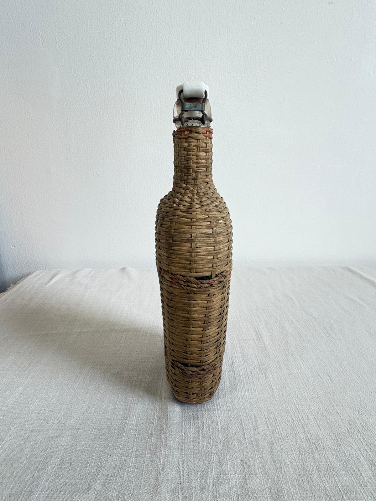 Vintage Lourdes Rattan Wrapped Bottle with Ceramic Swing Top Stopper - Collector & Curator