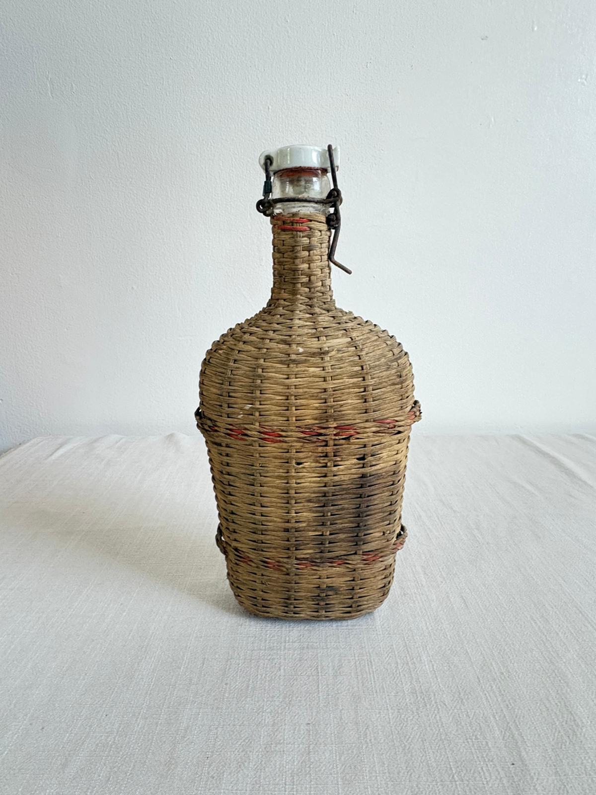 Vintage Lourdes Rattan Wrapped Bottle with Ceramic Swing Top Stopper - Collector & Curator