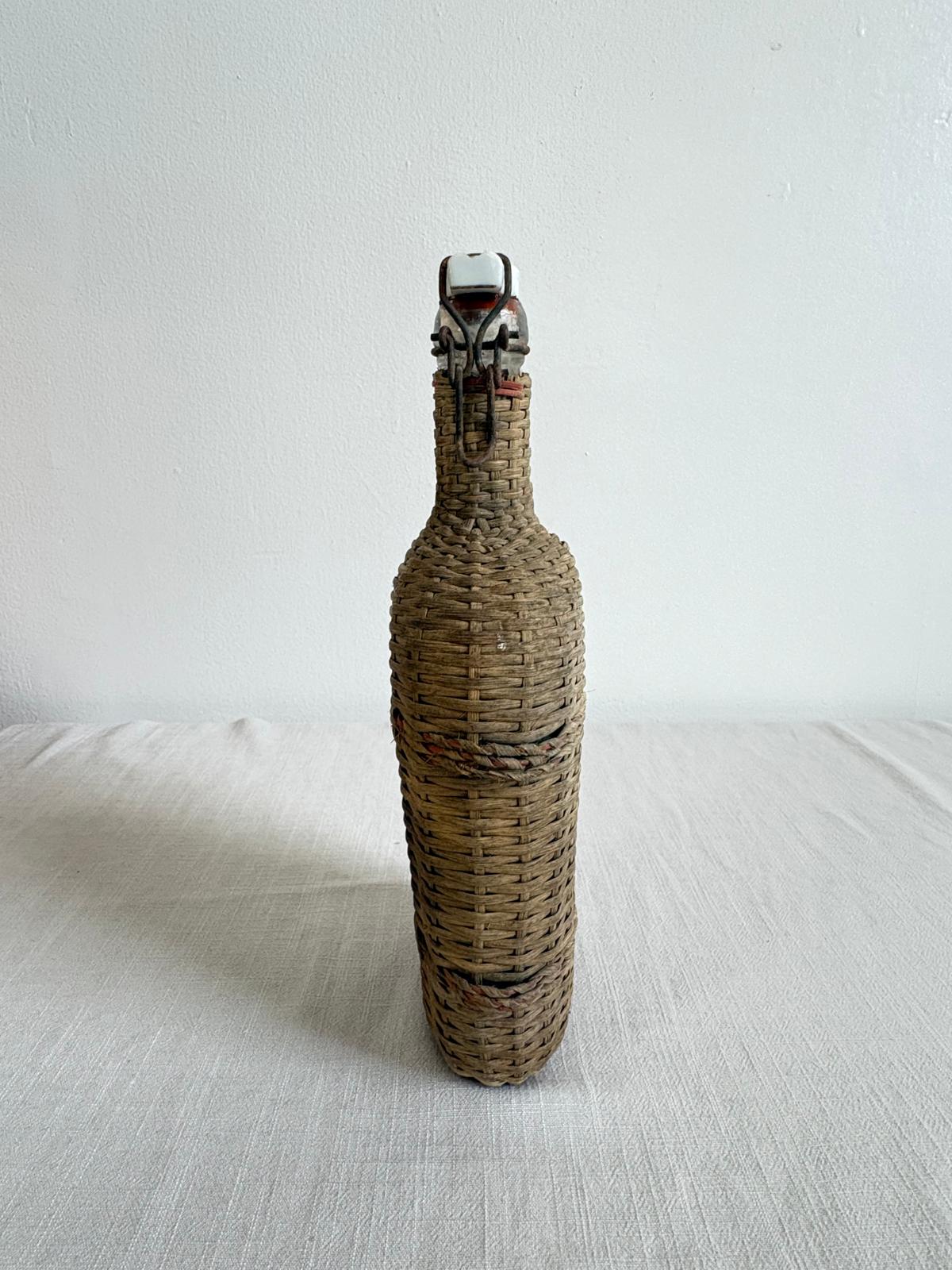Vintage Lourdes Rattan Wrapped Bottle with Ceramic Swing Top Stopper - Collector & Curator